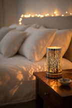 Silver Tree LED Oil Burner glowing amber on bedroom nightstand