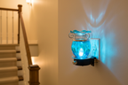 Blue tie dye ball wall burner plugged into staircase wall outlet glowing blue