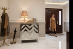 Mirrored chevron cabinet in entryway hallway with woman