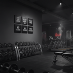 Four 12x12 inch black framed motivational canvas prints in gym on dark wall, true to scale