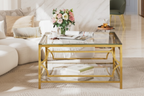 Square Glass Coffee Table with Gold Frame and clear glass top styled with pink roses in a bright luxury living room