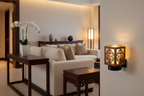 Antique round wood wall plug-in oil warmer in modern Asian-fusion living room glowing warm