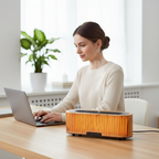 Woman working at office desk with aroma diffuser