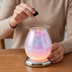 Person pouring fragrance oil into White Drizzles lamp